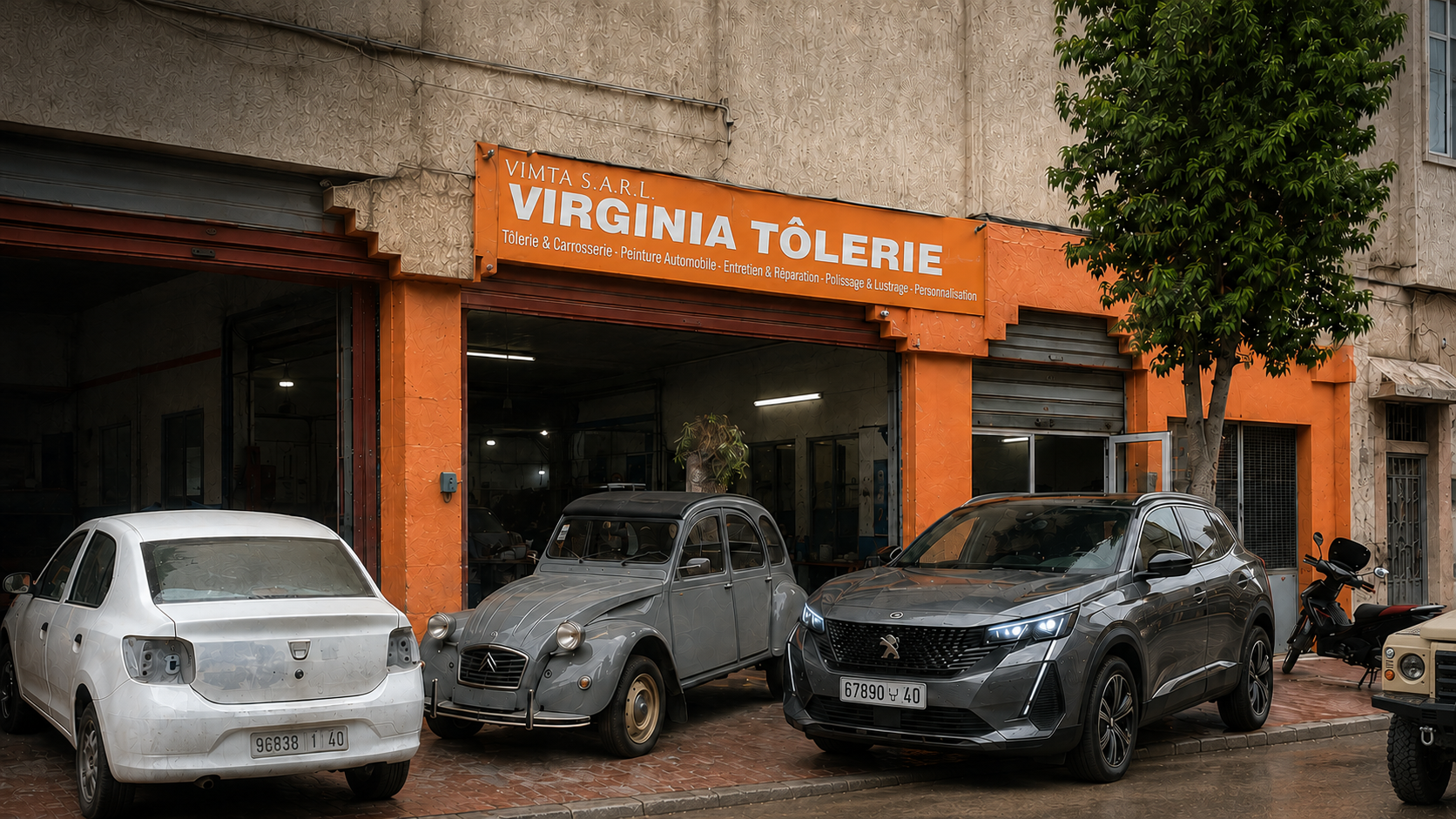 Façade du garage Virginia Tôlerie à Kénitra avec SUV et aperçu du Land Rover Defender 110 de 1998 restauré